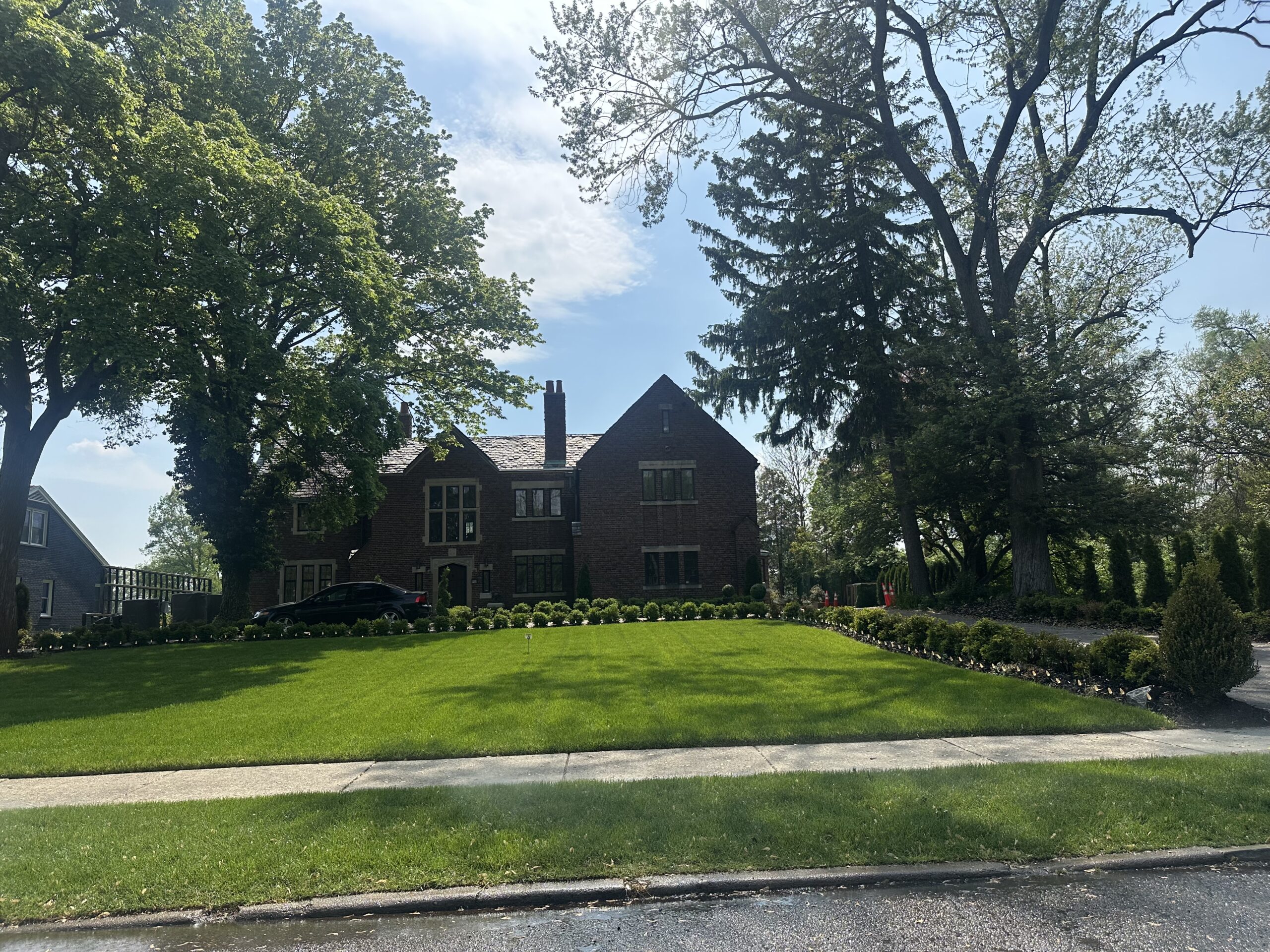 Aretha Franklin's former home, the brick Tudor-style Rose Estate, behind a wide front lawn in Detroit