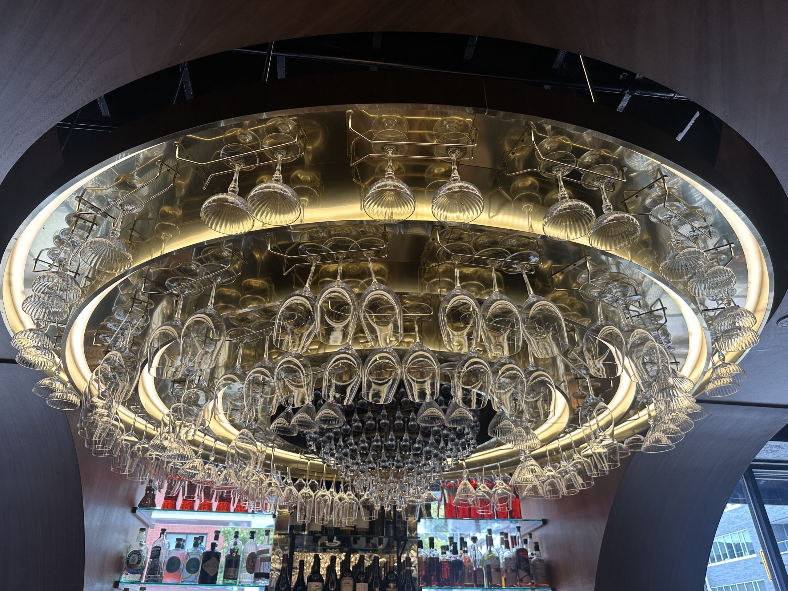 Chandelier of hanging wine glasses over the bar at Little Bella's Pizza & Wine Bar in Royal Oak