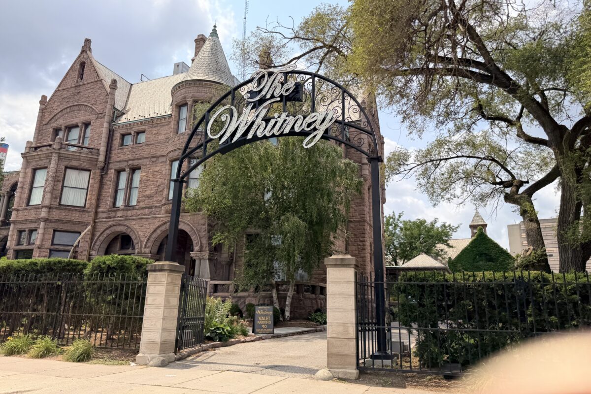 Gated entrance and red-stone mansion of The Whitney restaurant on Woodward Avenue, Detroit